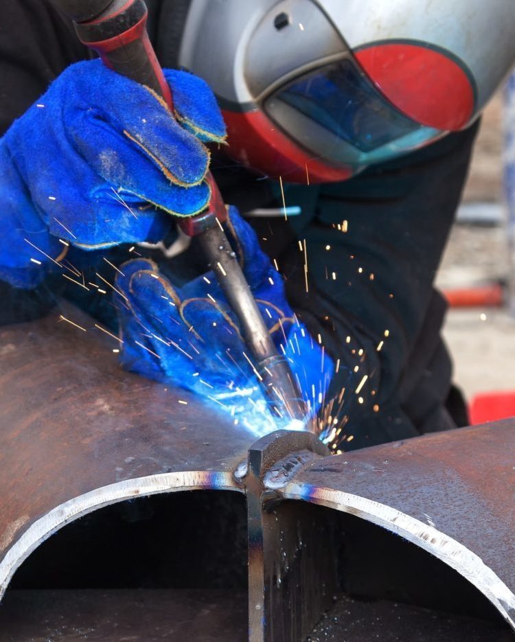 Welding work, welder welding metal material in heavy industry manufacturing